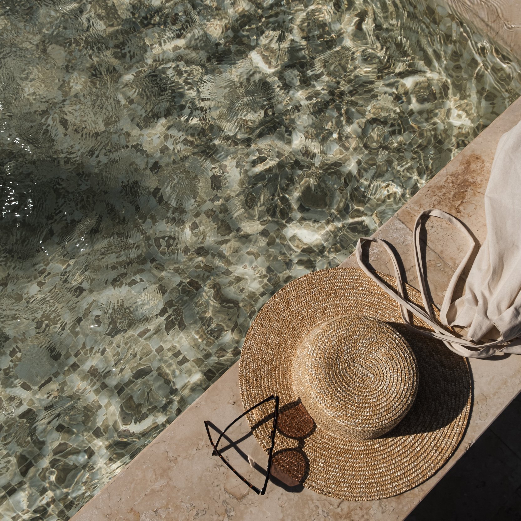 Sunglasses and Straw Hat on Swimming Pool Side 